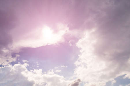 Sun and beautiful pink white clouds in the blue sky, background