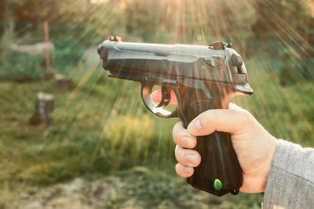 Female hand with pneumatic gun, outdoors close-upの写真素材