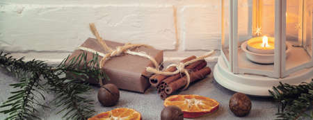 Christmas composition - lantern with burning candle and traditional ornamentsの写真素材