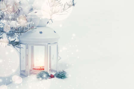 Christmas composition - a lantern with a burning candle and decorations under the Christmas tree,...
