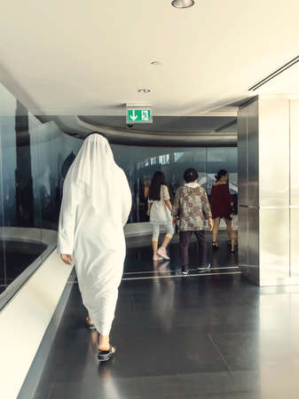 Dubai, United Arab Emirates - December 21, 2018: interior of the Burj Khalifa tower, a man in...