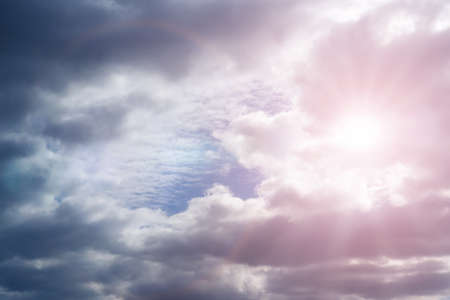 Sky with cumulus clouds and sunbeams on a summer dayの写真素材