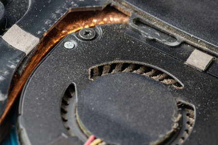 Very dirty, dusty laptop cooling system inside. Notebook with cover removed for cleaning and repairの写真素材