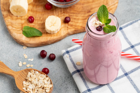 Homemade yogurt smoothie with banana, cranberry and oatmealの写真素材