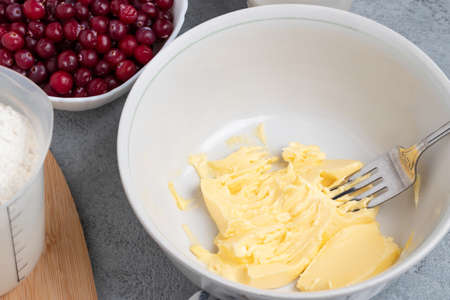 Making a dough for a sweet cranberry pie. Melted butter in a bowl
