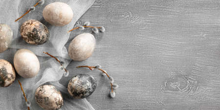 Easter composition - several painted with natural dyes with marble effect on the table, top view, copy spaceの写真素材