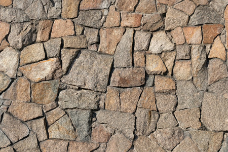 Stone wall of granite close-up, texture, background.の写真素材
