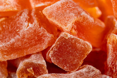 Close-up of Natural farm homemade candied pumpkin fruits sprinkled with powdered sugar, food background, textureの写真素材