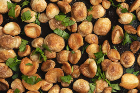 Cooking edible puffball mushrooms. Fried mushrooms in a cast iron pan, top view