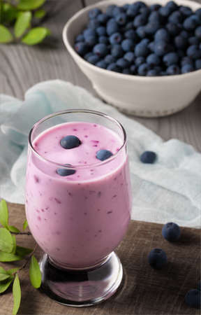 Homemade blueberry yogurt smoothie. Protein shake with berries. Vertical imageの写真素材