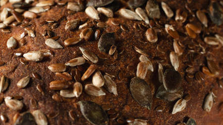 Close-up surface of homemade whole grain bread, food background, textureの写真素材
