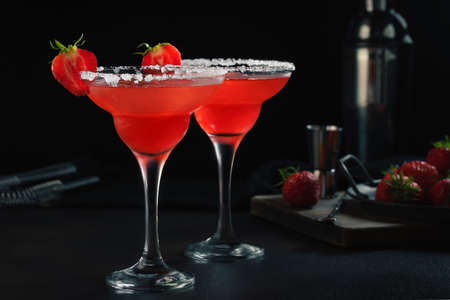 Fresh homemade refreshing strawberry cocktail margarita in glasses on the tableの写真素材