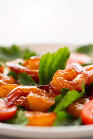 Close-up of fresh shrimp, tomato, arugula and greens salad, vertical image with copy spaceの写真素材