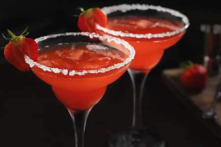 Fresh homemade refreshing strawberry cocktail margarita in glasses on the tableの写真素材