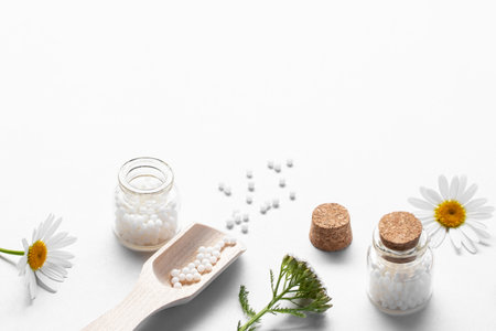 Homeopathic medicines and medicinal plants on a light background, copy spaceの写真素材