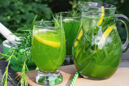 Homemade summer refreshing tarragon lemon drink on patio tableの写真素材