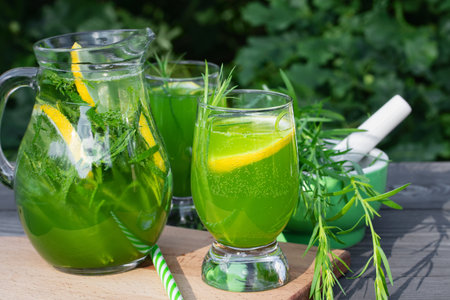 Homemade summer refreshing tarragon lemon drink on patio tableの写真素材