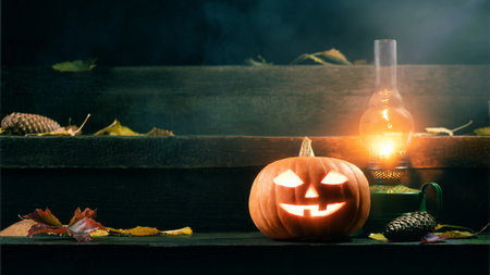 Halloween Pumpkin Jack-O-Lantern and a kerosene lamp on the porch of a house protects against evil spirits