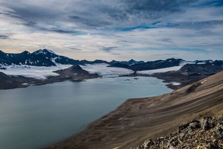 Glacier and mountain range under the clouds, Svalbardの写真素材