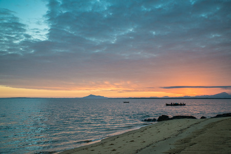 Fishermans rowing in a boat at sunrise, Madagascarの写真素材
