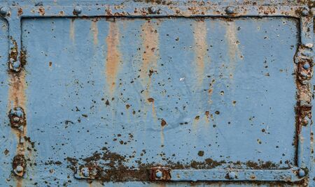 Old rusted metal plate with rivetsの写真素材
