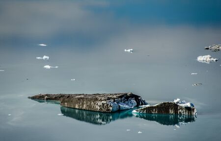 Small icebergs and reflections near a glacier, Greenlandの写真素材
