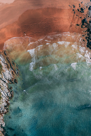 Surfer in Sonabia beach in Cantabrian sea, Spain - drone aerialの写真素材