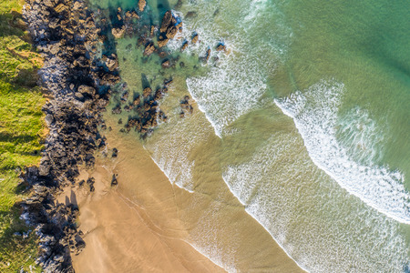 Waves in Sonabia beach in Cantabrian sea, Spain - drone aerialの写真素材