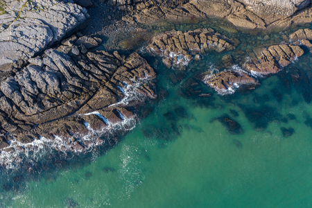 Sea waves breaking in the reefs and coast of Sonabia, Spain, Cantabrian sea - drone aerial viewの写真素材