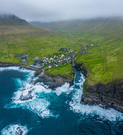 Natural harbour gorge in Gjogv village aerial view, Faroe islandsの写真素材