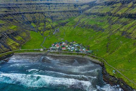 Tjornuvik village and beach and waterfalls aerial view, Faroe Islandsの写真素材