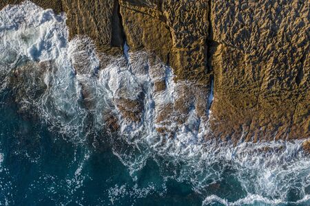 Sea waves breaking in the reefs and coast, Cantabrian sea, Spain - drone aerial view