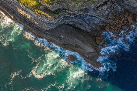 Sea waves breaking in the reefs and coast, Cantabrian sea, Spain - drone aerial view