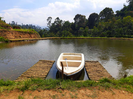 A small boat moored in a lakeの写真素材