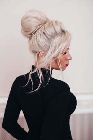 beautiful blonde hair girl with fashion hairstyle in black dress