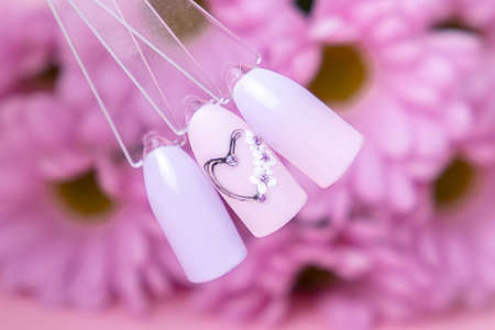 Romantic color palette of nail gel polish for manicure and pedicure nails, heart designの写真素材