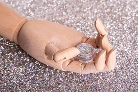 Wooden hand near gel polish. Manicure and nail care concept.の写真素材