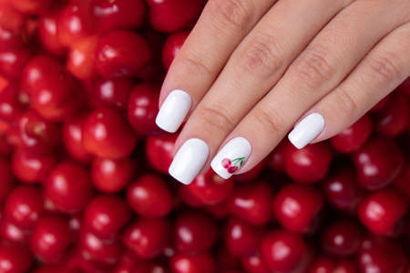 Beautiful female hands with white manicure nails