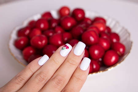 Beautiful female hands with white manicure nails