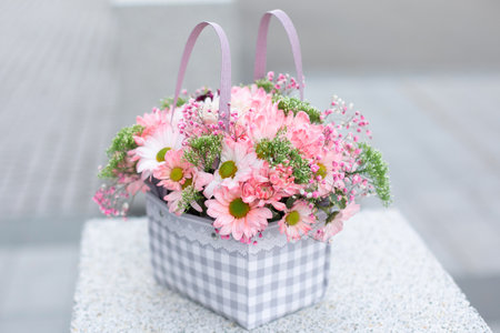Bouquet of beautiful pink and white flowers, peonies, roses in craft packageの写真素材