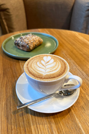 Coffee cappuccino and chocolate cake in cafeの写真素材