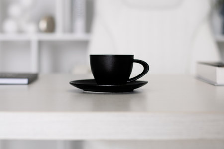 Black cup of coffee on office table for business man