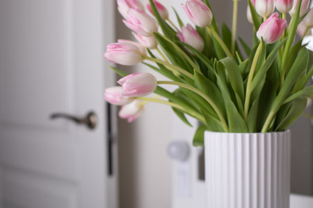 Bouquet of beautiful pink tulips flowers in vase on tableの写真素材