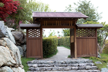 Japanese Garden Gate with Stone Steps and Lush Greeneryの写真素材