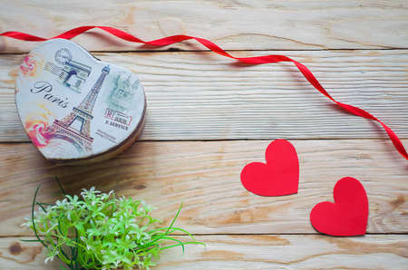 Hearts, flowers, ribbons on a wooden light backgroundの写真素材