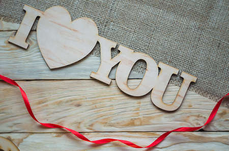 Hearts, flowers, ribbons on a wooden light backgroundの写真素材