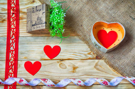 Hearts, flowers, ribbons on a wooden light backgroundの写真素材