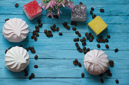 Cooked black coffee with sweet marshmallow on a blue wooden tableの写真素材