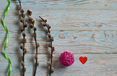 Bouquet willow branch and Easter eggs on a wooden table for a festive moodの写真素材