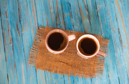 Cooked black coffee with sweet marshmallow on a blue wooden tableの写真素材